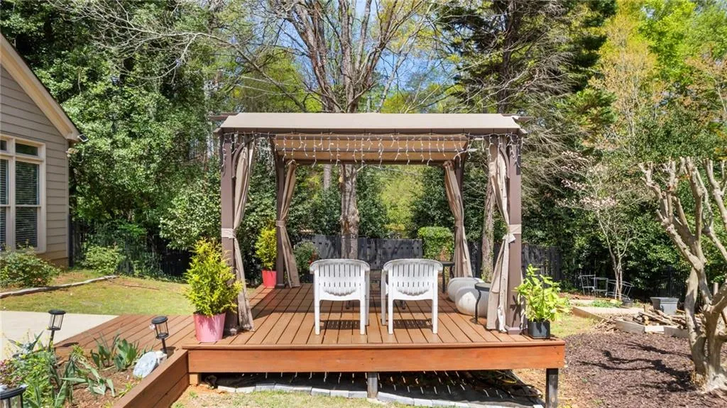 Wooden terrace featuring fence
