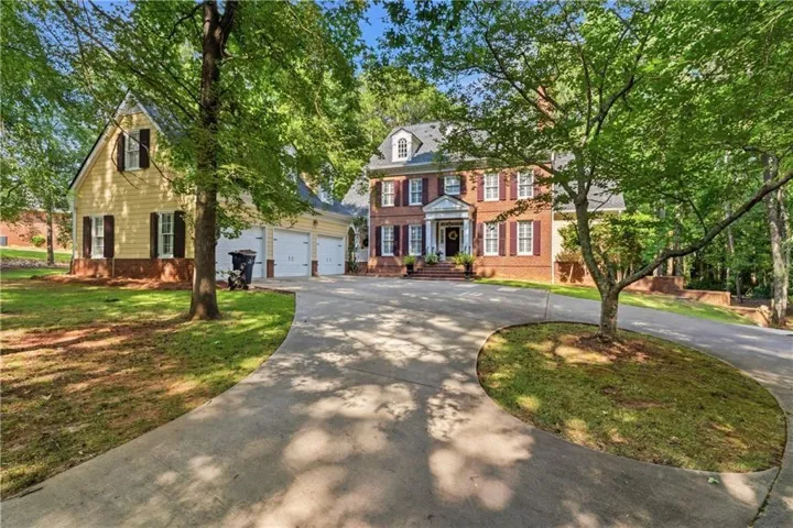 Brick exterior with white columns and shutters