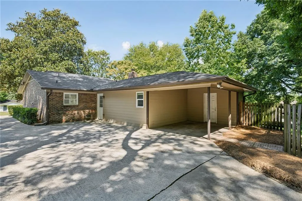 Carport and driveway with loads of room for cars or basketball!