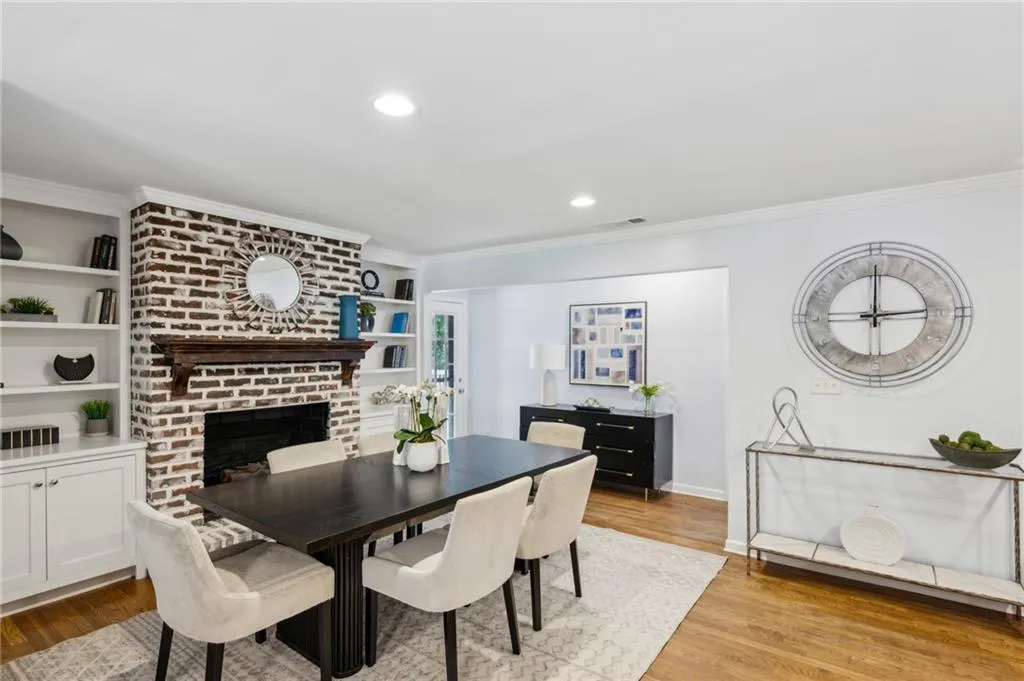Dining area with brick fireplace and built-in cabinets