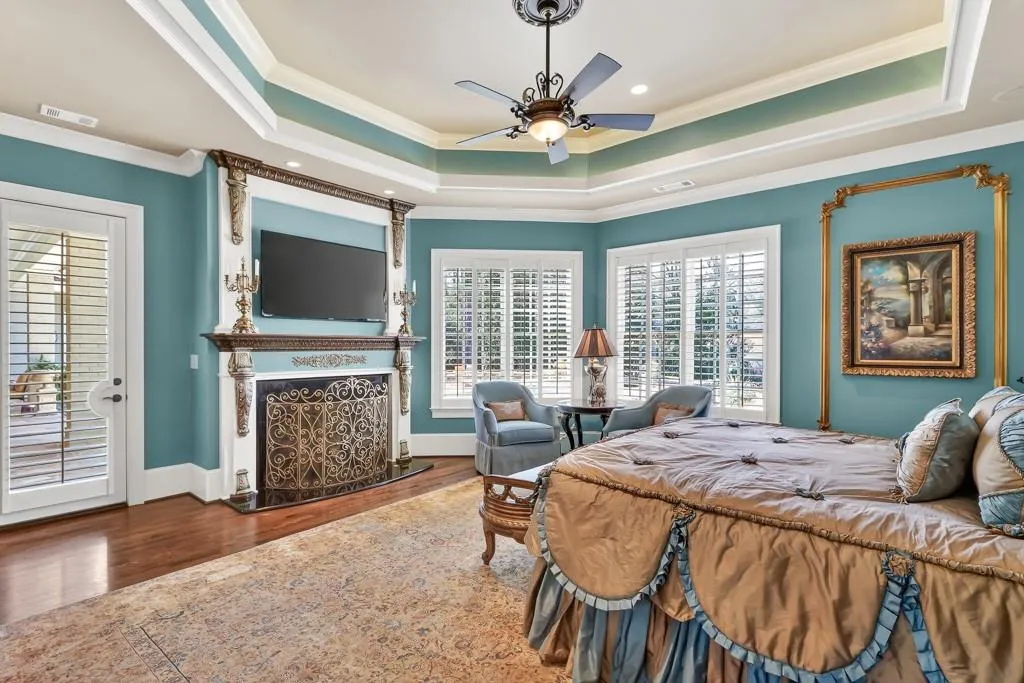 Primary bedroom with Fireplace, 12' Tray Ceiling, Double Windows, Door to Veranda/Pool