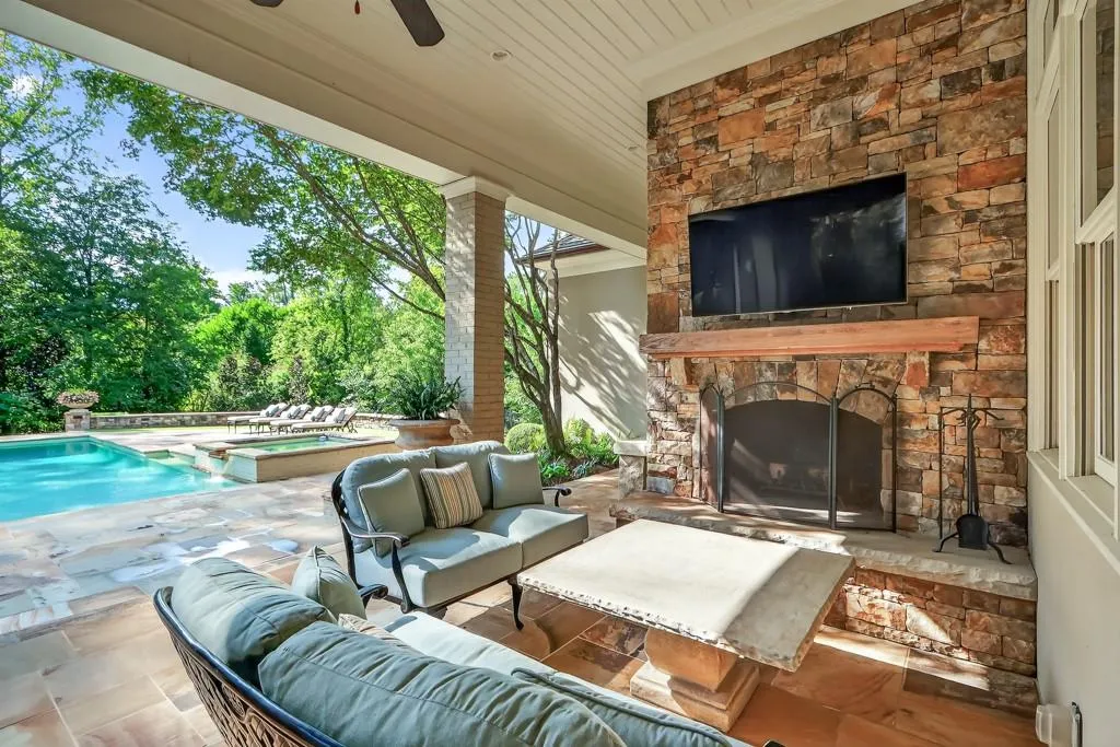 Stacked stone fireplace with outdoor TV