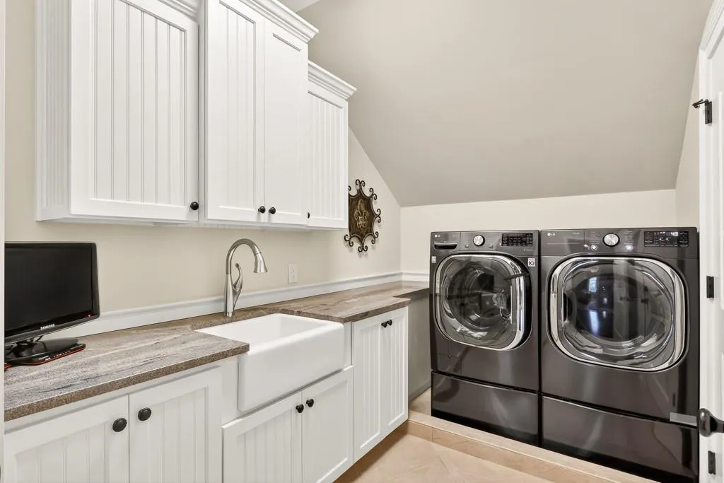 Upstairs laundry room with sink and plenty of storage