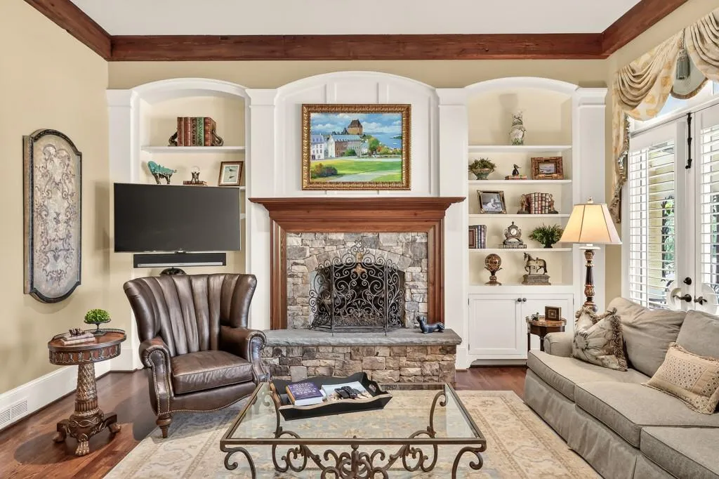 Family room with stacked stone fireplace and floor to ceiling windows