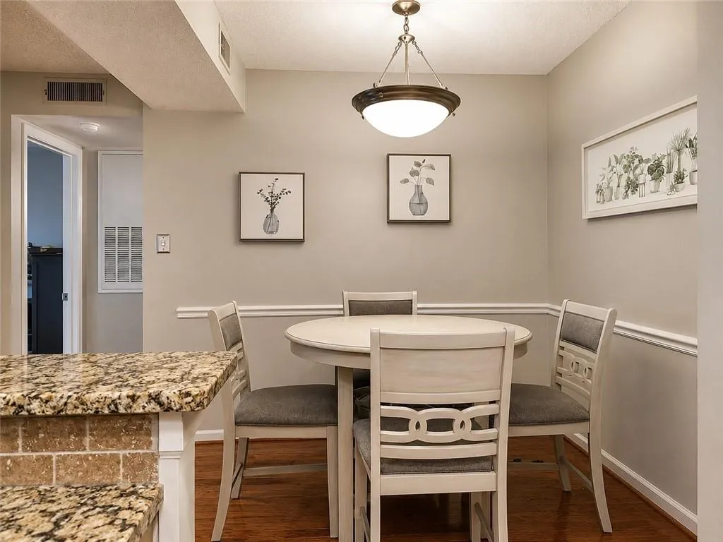 Dining area featuring a circular table, neutral wall paint, and wood-finish flooring