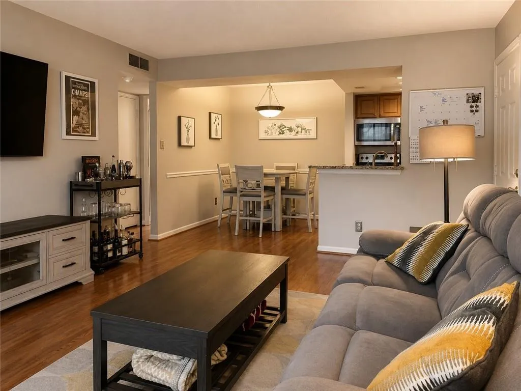 Open concept living space featuring wood-finish flooring throughout