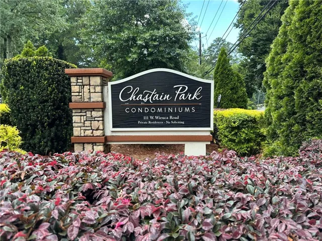 Chastain Park Condominiums signage featuring stone pillars and professional landscaping