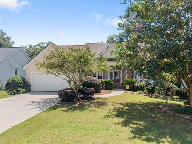 Single-story residence featuring a two-car garage, front porch, and a concrete driveway