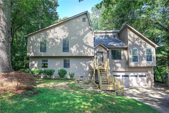 Multi-level exterior with light-toned horizontal siding