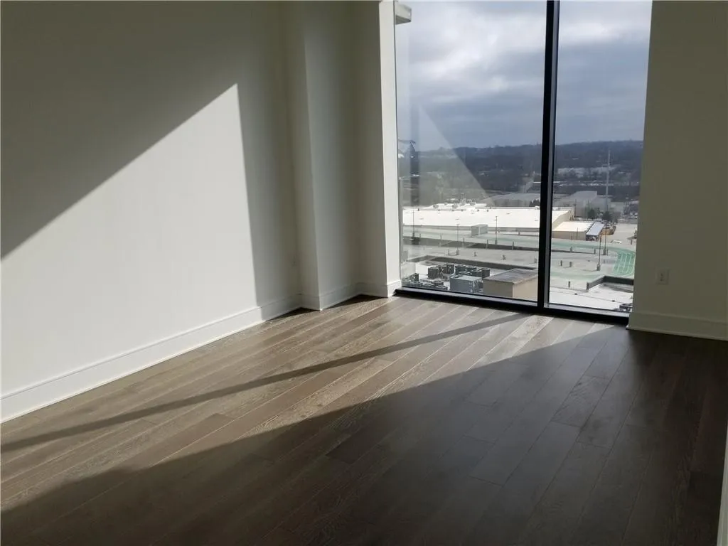 Empty room with hardwood / wood-style floors