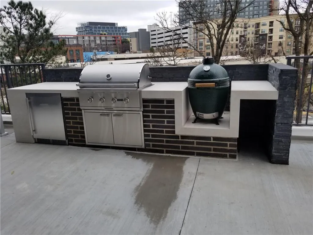 View of patio featuring an outdoor kitchen and grilling area