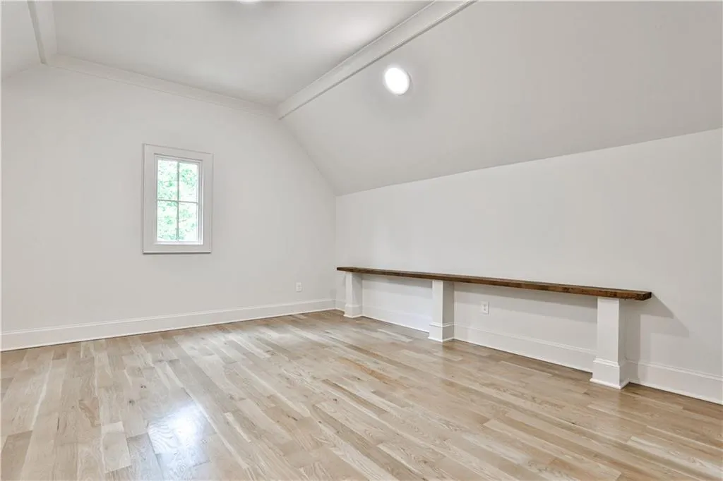 Bonus/computer/play room off one of upstairs bedrooms with light hardwood / wood-style floors and vaulted ceiling