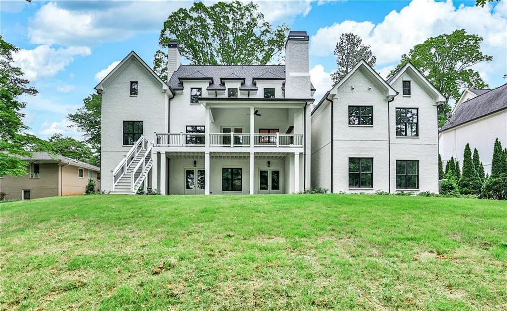 Rear view of house featuring a yard