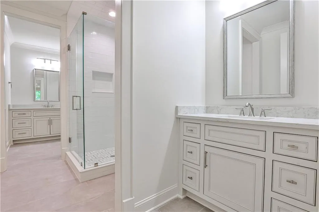 Bathroom with tile flooring, vanity, an enclosed shower, and crown molding
