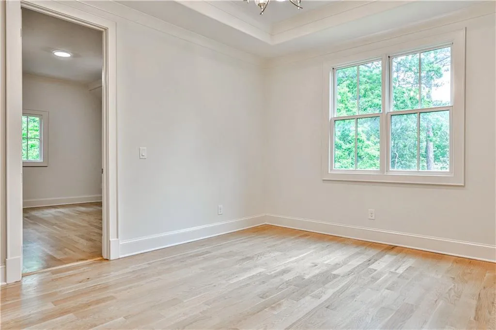 Spare room featuring plenty of natural light and light wood-type flooring