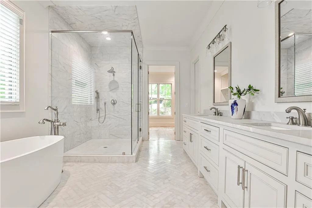 Bathroom featuring ornamental molding, double vanity, tile flooring, and plus walk in shower