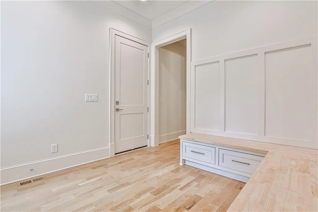 Mudroom on main level with light wood-type flooring