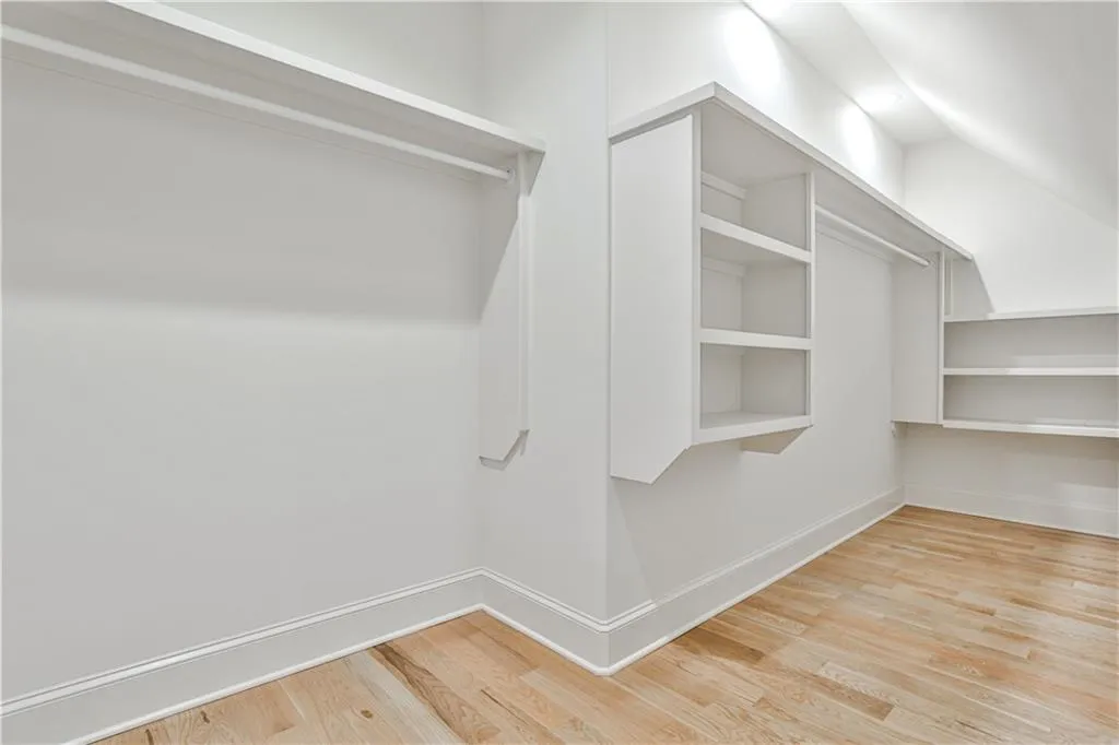 Spacious closet with light hardwood / wood-style floors