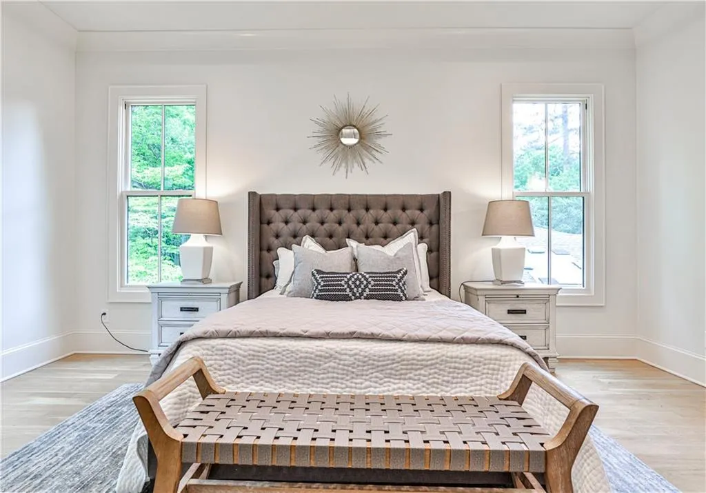 Bedroom featuring wood-type flooring and multiple windows