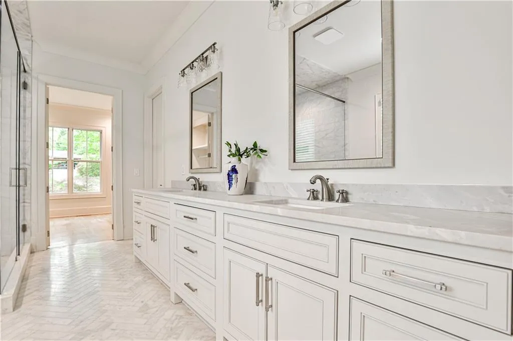 Bathroom with walk in shower, dual vanity, and ornamental molding