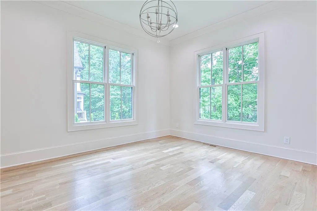 Empty room with a healthy amount of sunlight and light wood-type flooring