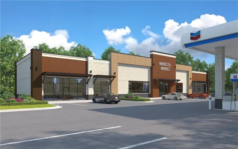 View of commercial property featuring uncovered parking