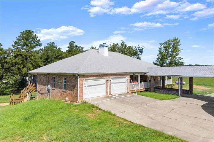 Brick exterior with a light gray shingle roof