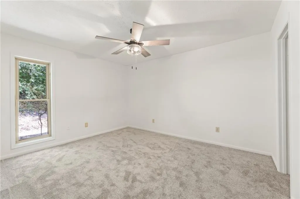 Spare room featuring ceiling fan and carpet Spare room featuring ceiling fan and carpet