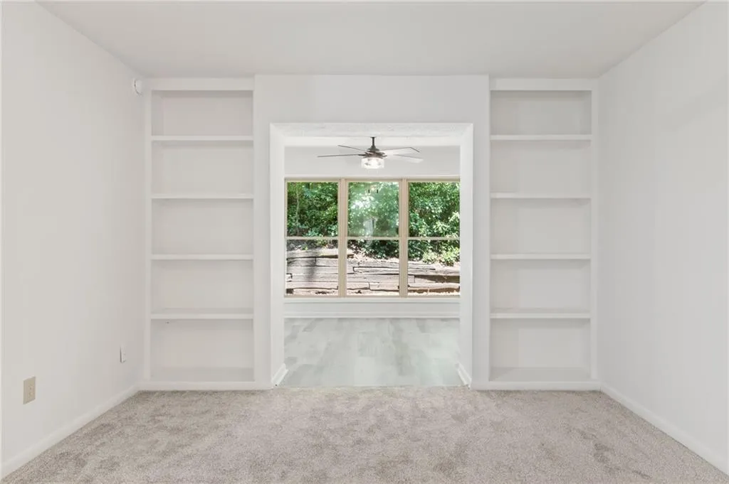 Carpeted empty room with ceiling fan Carpeted empty room with ceiling fan