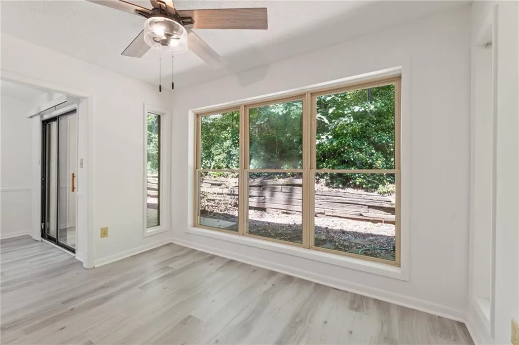 Spare room featuring light hardwood / wood-style flooring and ceiling fan Spare room featuring light hardwood / wood-style flooring and ceiling fan