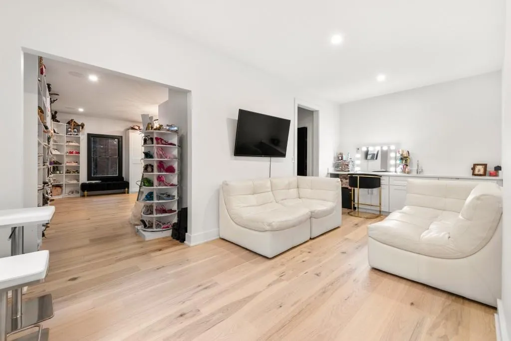 Bonus room used as closet with seating area and half bath
