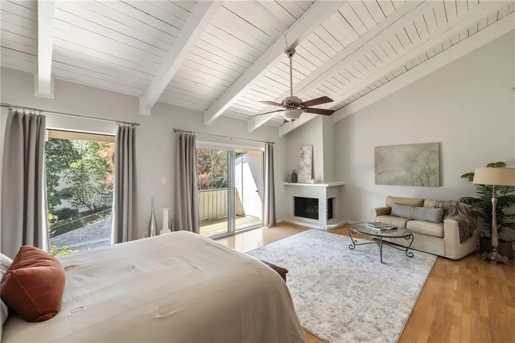 Primary Bedroom has 2-sided fireplace and sliding glass doors that open onto a private deck