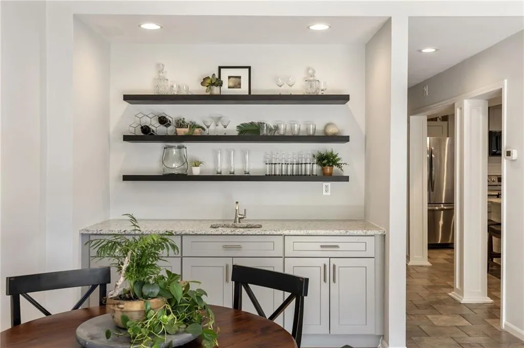 Large recessed wet-bar with additional cabinet storage, beverage cooler an floating shelves