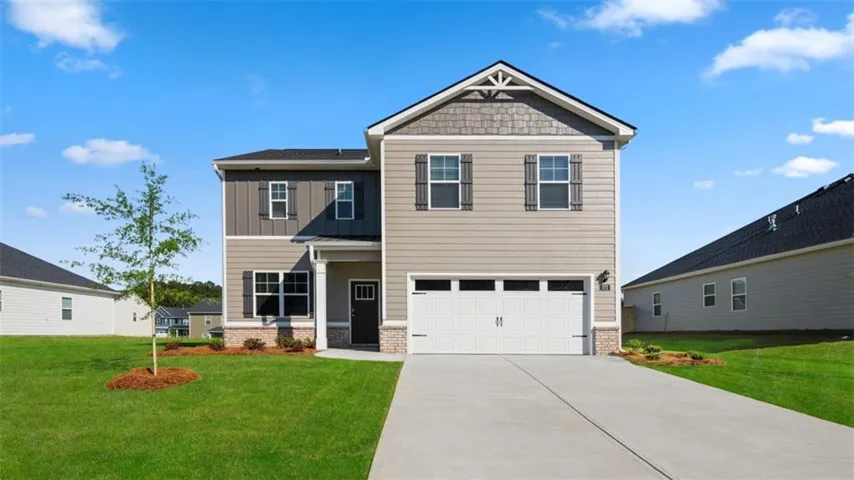Two-story exterior with multi-toned siding, a prominent gable, and a two-car garage