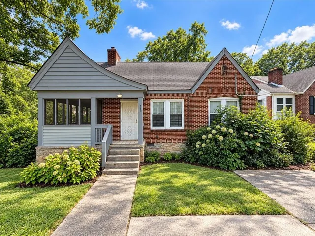 Brick exterior with a gabled roof and covered front porch