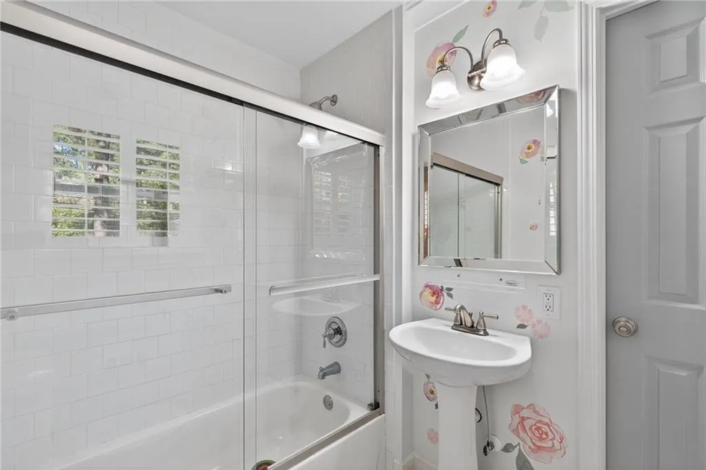 Full bath with shower / bath combination with glass door