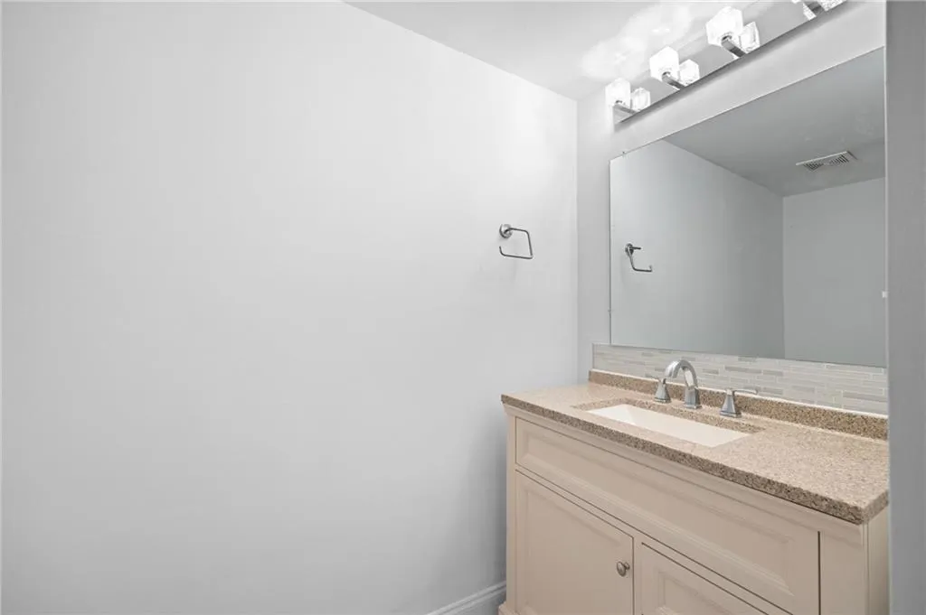Bathroom featuring backsplash and vanity