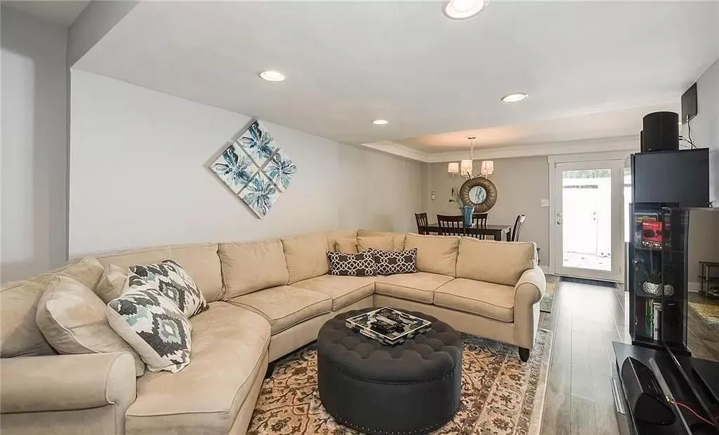 Living room with a chandelier and light wood-type flooring