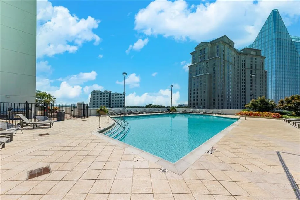 Outdoor swimming pool with integrated steps and metal handrails