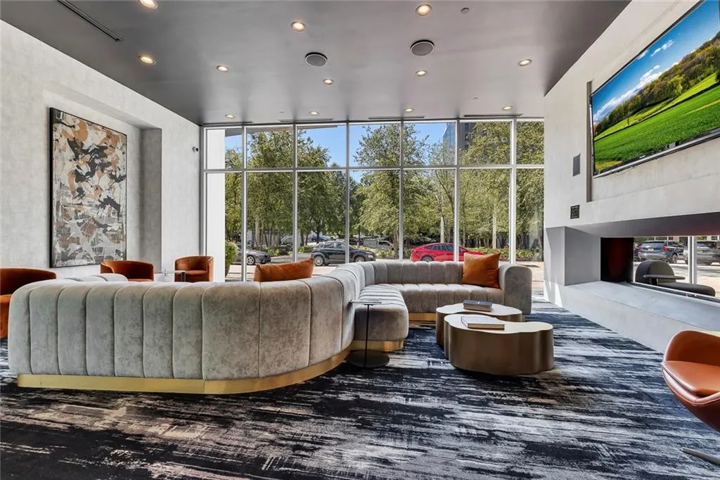 Expansive window wall, recessed lighting, built-in television, and an integrated fireplace