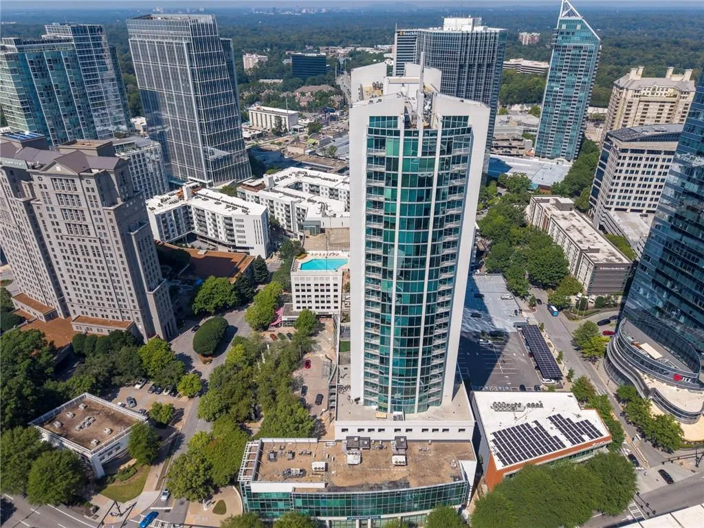 High-rise building with a curved glass facade and white architectural elements
