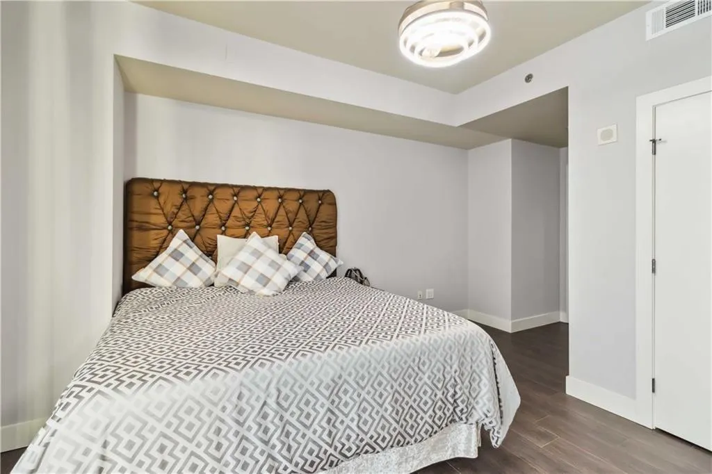 Bedroom with baseboards and wood finished floors
