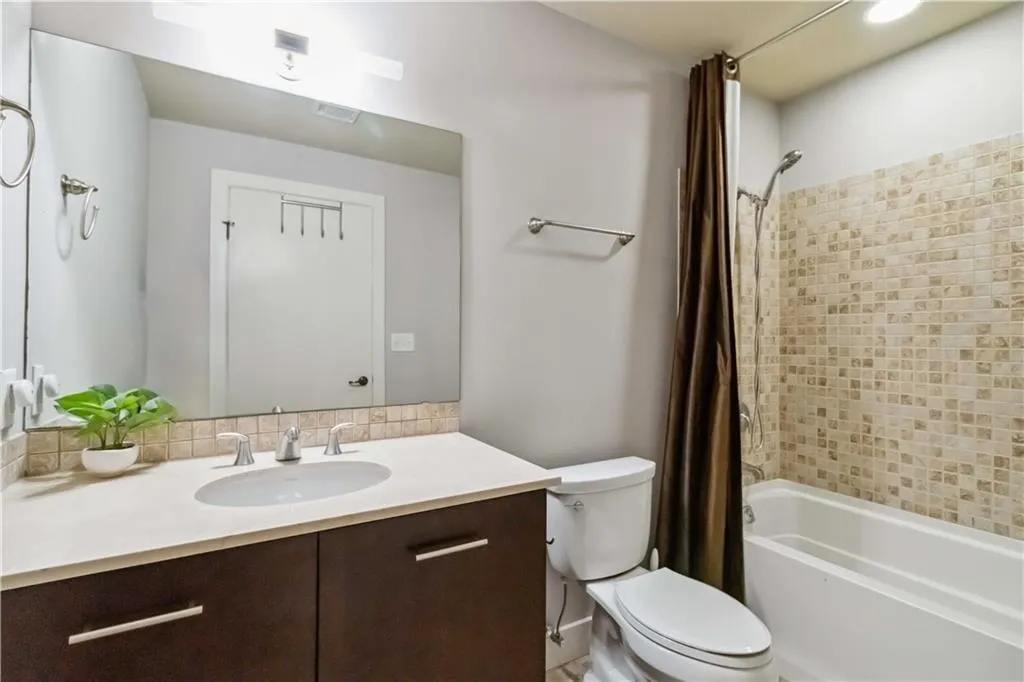 Full bathroom with vanity and shower / tub combo