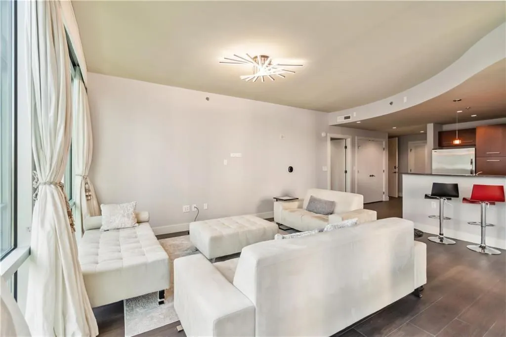 Living room with dark wood-style flooring and recessed lighting