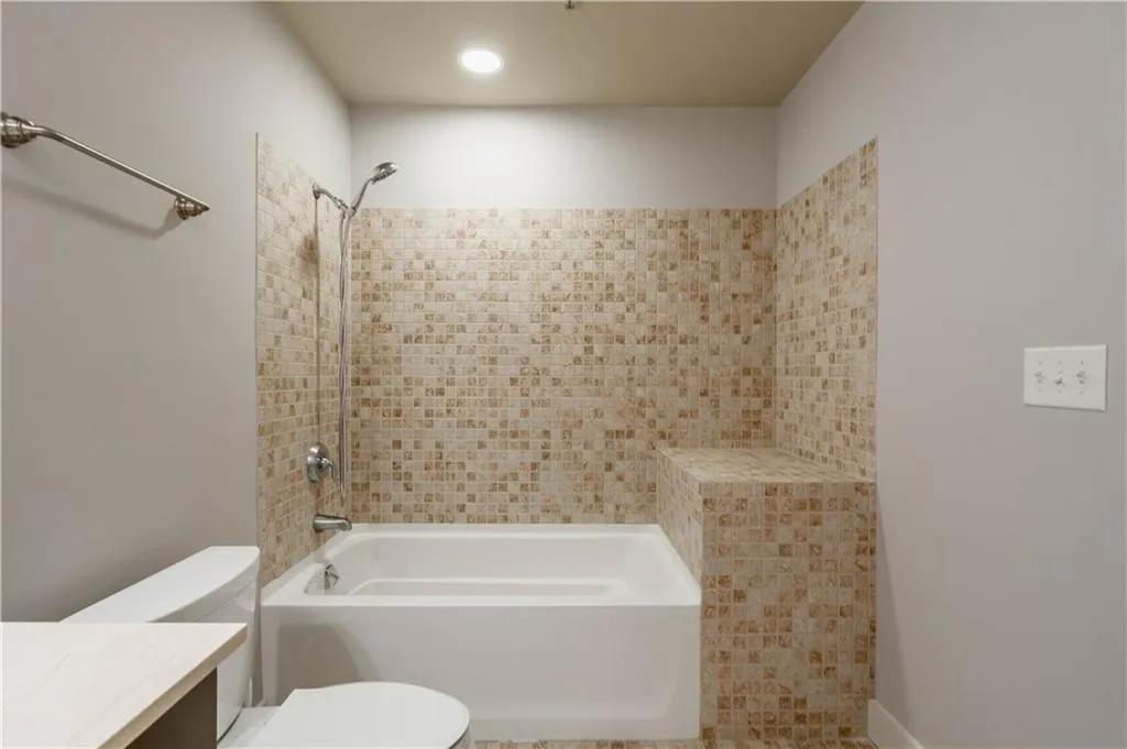Full bath featuring shower / washtub combination and vanity