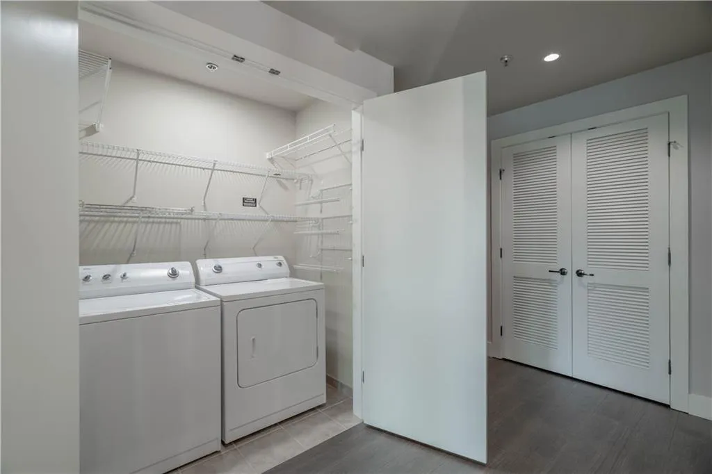 Laundry room with washer and dryer, recessed lighting, and tile patterned flooring