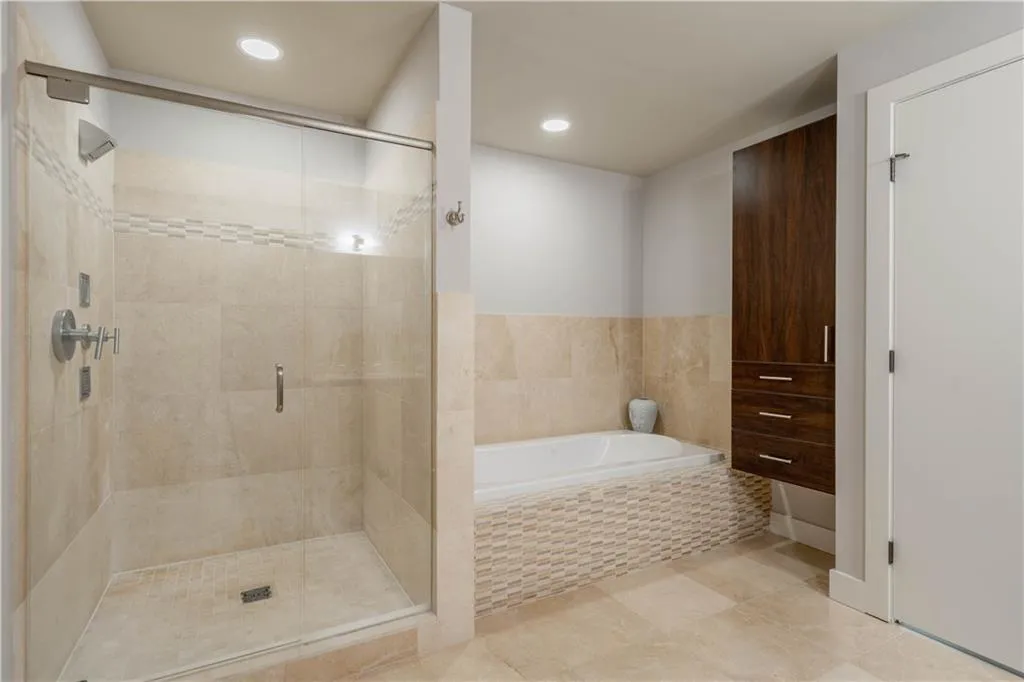 Bathroom with a bath, a stall shower, and recessed lighting