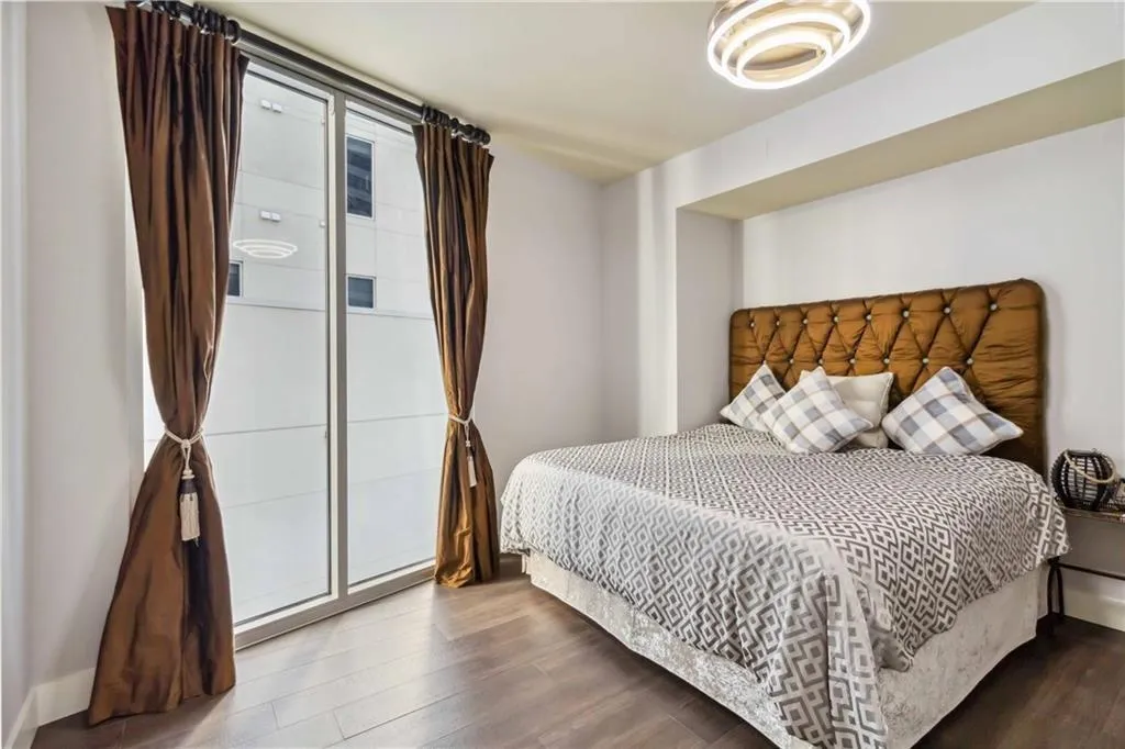 Bedroom with wood finished floors and baseboards