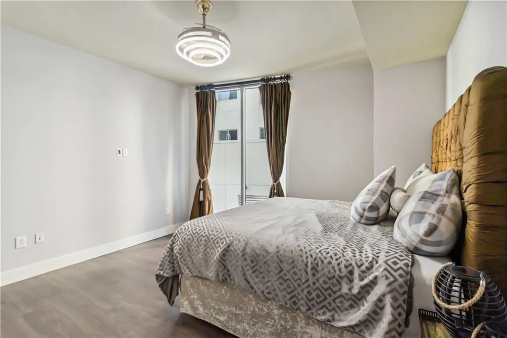 Bedroom with baseboards and wood finished floors