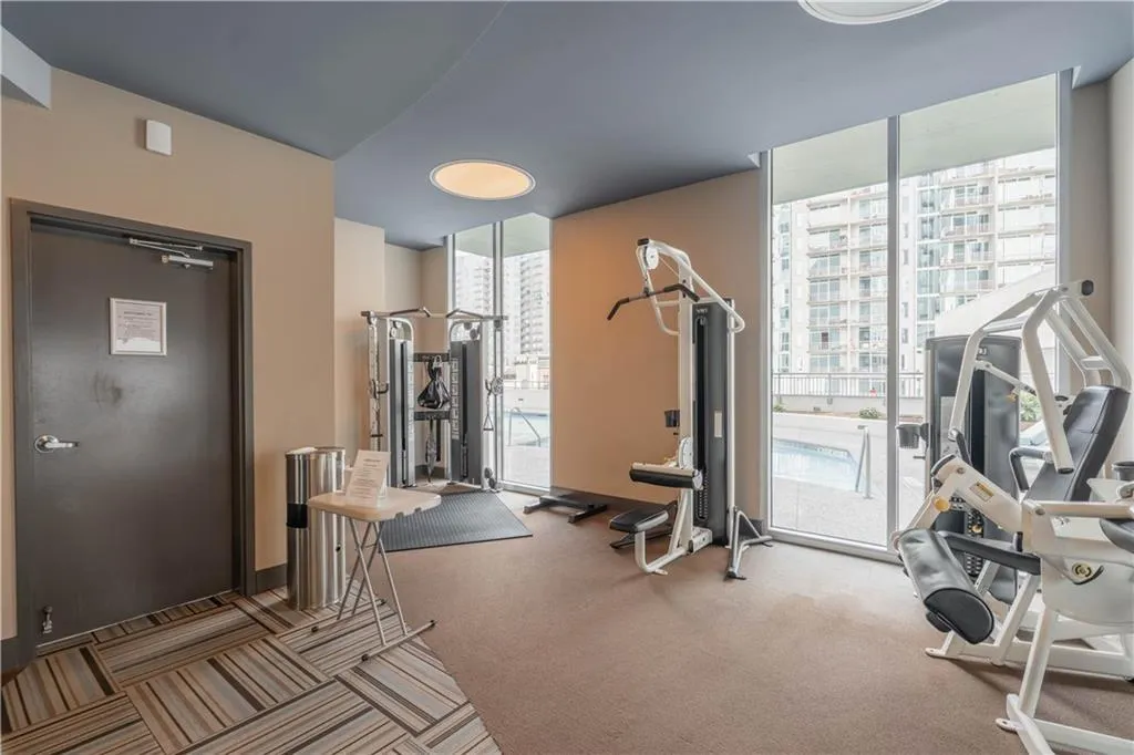 Workout area with expansive windows and carpet floors
